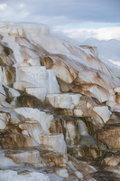 Hot water flows over travertine terraces.