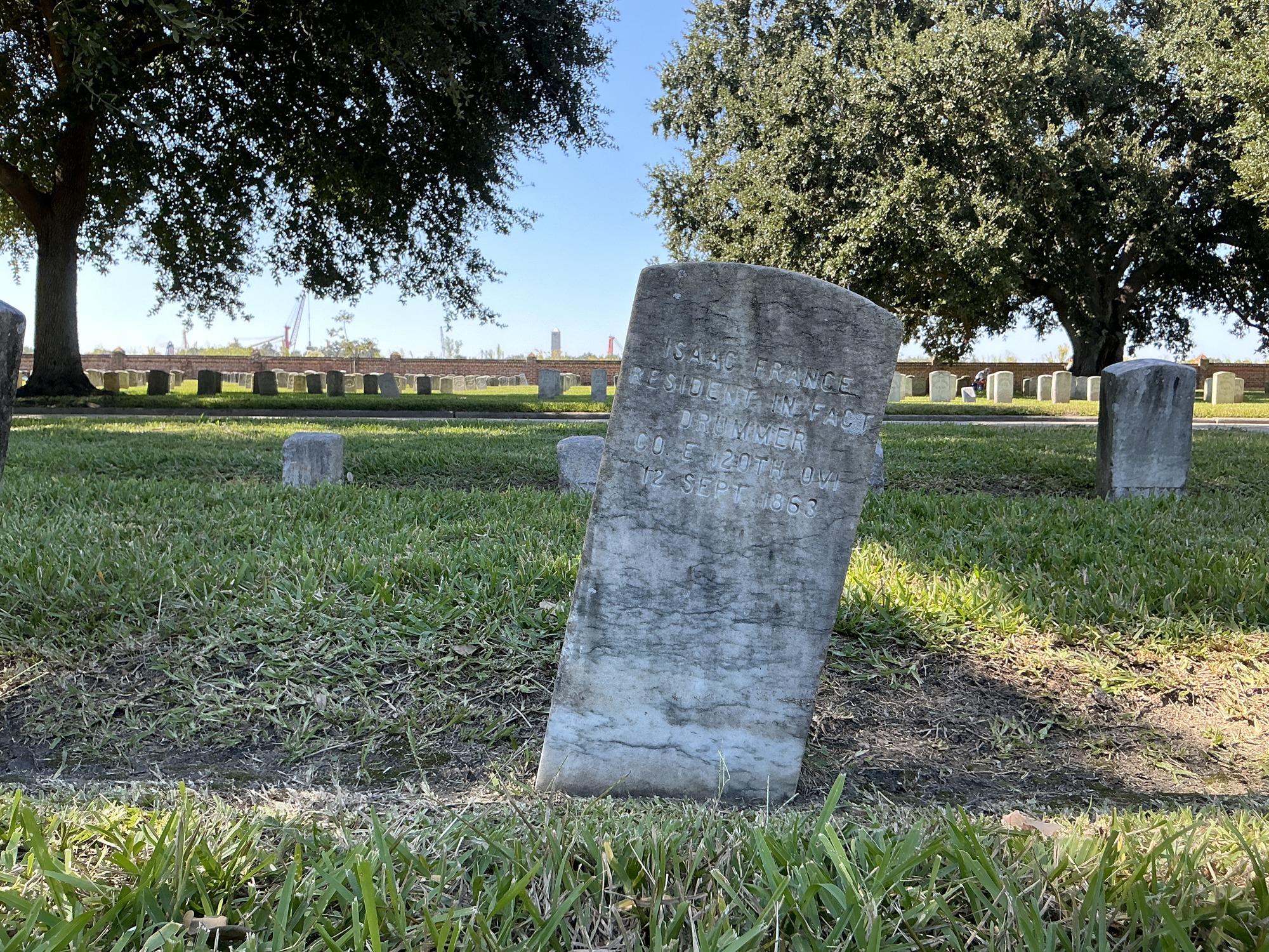 Back of historic upright marble headstone with recessed shield face.