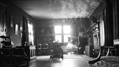 A young girl reads by the light of the window in the living room of the house in Branchville, Connecticut.