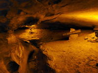 A very narrow trail leads into a small passage. 