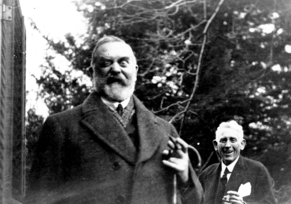 Two older men, both in suits.