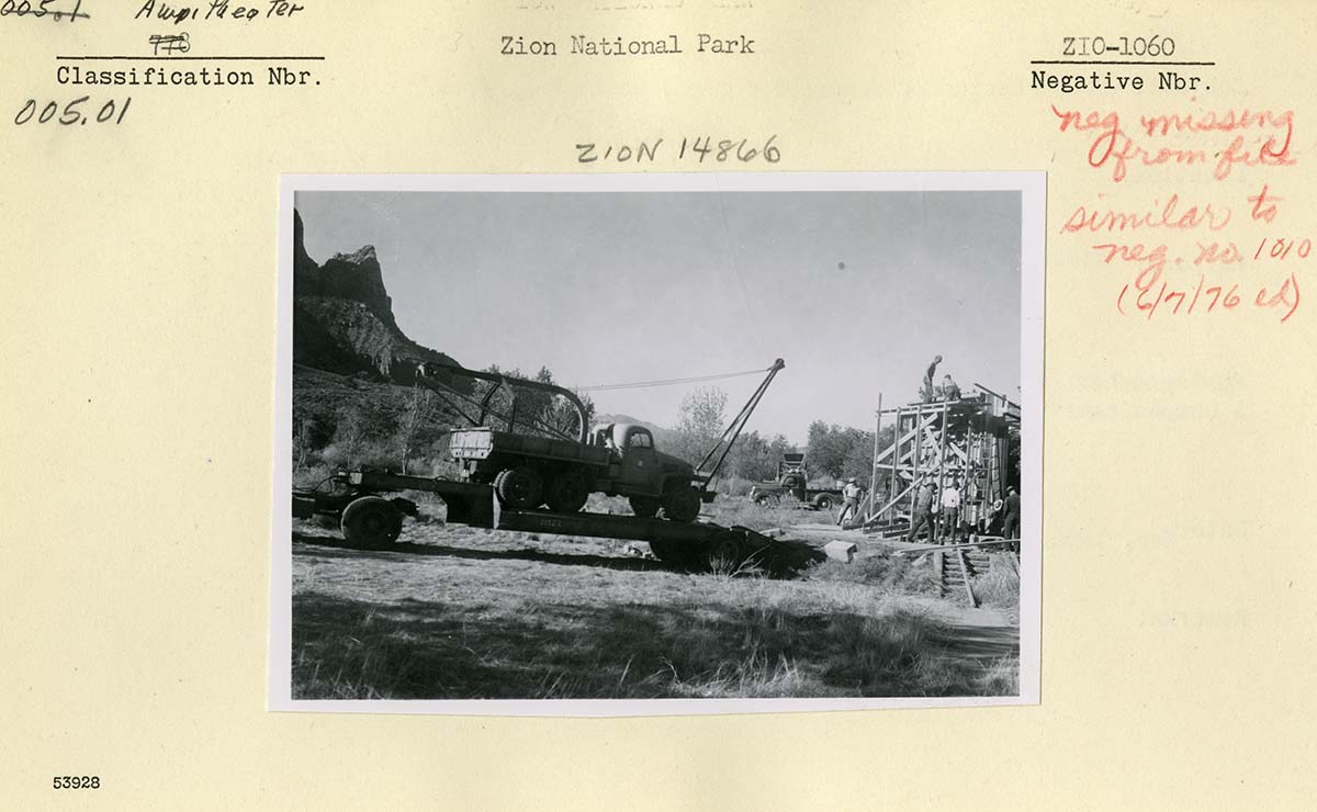 Construction of concrete screen, South Campground, truck with crane on trailer.