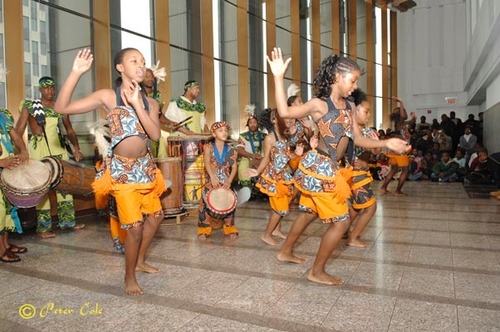 A group of young female dancers perform for a standing room only crowd during the 2007 Kwanzaa celebration at African Burial Ground NM.