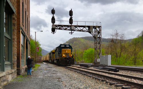 train alongside brick buildings