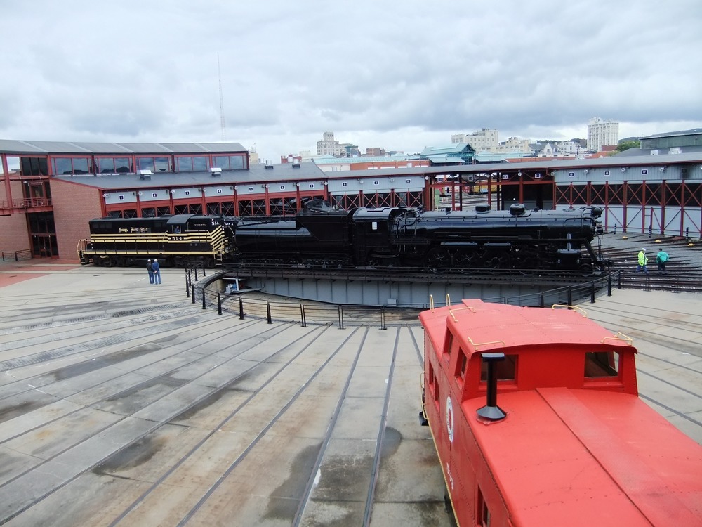 Grand Trunk Western #6039, assisted by NKP #514, moves from the turntable to Roundhouse for storage and display.