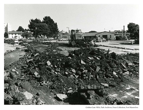 Bulldozer tearing up pavement behind Building 101 at Fort Mason, 1978.