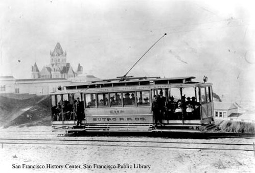 Adolph Sutro inaugurated electric streetcar operations to the Cliff House in 1896, the same year he opened his grandiose new ‘French chateau’ Cliff House and the expansive Sutro Baths. Built as an alternative to the Ferries & Cliff House steam train that wound its way around Land’s End, the “Sutro Rail Road Company” electric cars offered inexpensive transportation direct to the new Baths. Passengers got off the Sutro streetcars in a covered depot (adjacent to today’s Louis’ Restaurant), where a covered walkway led directly to the Baths’ main entrance. In an era when horse cars and steam-powered locomotives still plied the streets of San Francisco, the Sutro Railroad’s silent, clean electric cars were truly state-of-the-art. As an incentive to riders, Sutro offered transfers ensuring a 5¢ fare from anywhere in the San Francisco. (The rival steam line was operated by the widely-hated Southern Pacific Railroad and didn’t respect transfers, a policy which resulted in a 10¢ fare for their riders.)