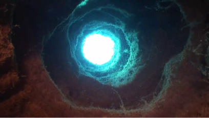 Scuba divers view looking up from bottom of Fumerole tube