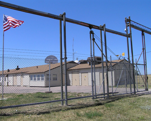 Fence and entry gate to a launch control facility