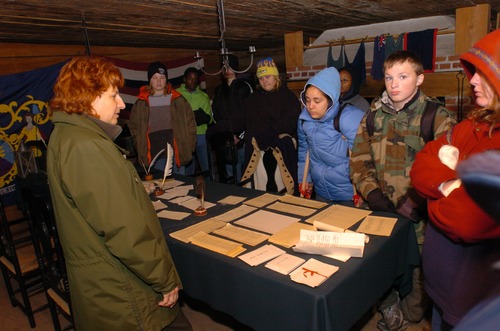 Fort Stanwix Soldier's Day program. A park ranger thanks children for their service in the continental army and gives them their pay and dismissal papers.