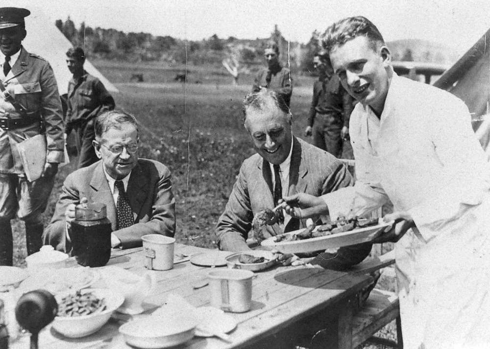 Franklin Delano Roosevelt's being served a meal during visit to CCC Camps Aug 1933.