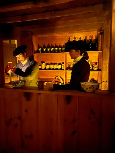 Two Park Rangers in colonial clothing behind the bar at Hartwell Tavern