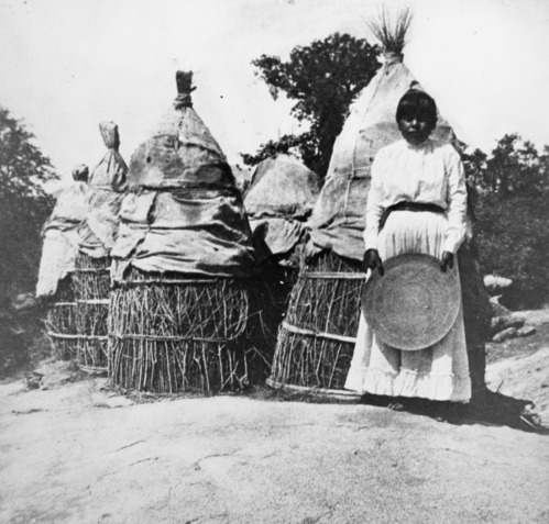 Copy Neg: April 2001, L. Radanovich. Woman with granary. Copied from the Frank Latta photo collection in the Yosemite Museum. (Box 5, Native Americans, Squaw Valley file).