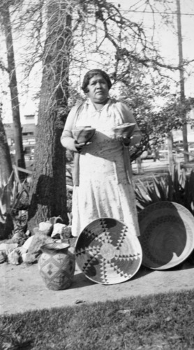 Copy Neg: April 2001, L. Radanovich. Minnie Wilcox and some of her baskets. Copied from the Frank Latta photo colleciton in the Yosemite Museum. (Box 5, Minnie Wilcox file).