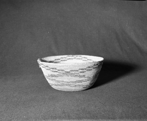 Marie Rozier Collection, Catalog No. 3. Object: Miwok cooking basket. Dimensions: 11 1/2 x 5 1/4". Materials: Redbud, split bull pine. Technology: Single rod, usually split; leftward coil direction; fag ends trimmed on work face; moving ends trimmed on backface; clock-spring start with row of stitching on interior hole of start. Collection History: From the Alice Reade collection. Photographed by Michael Dixon in December 1982. Catalogued by Craig Bates and Barbara Beroza. Yosemite Collections, National Park Service.