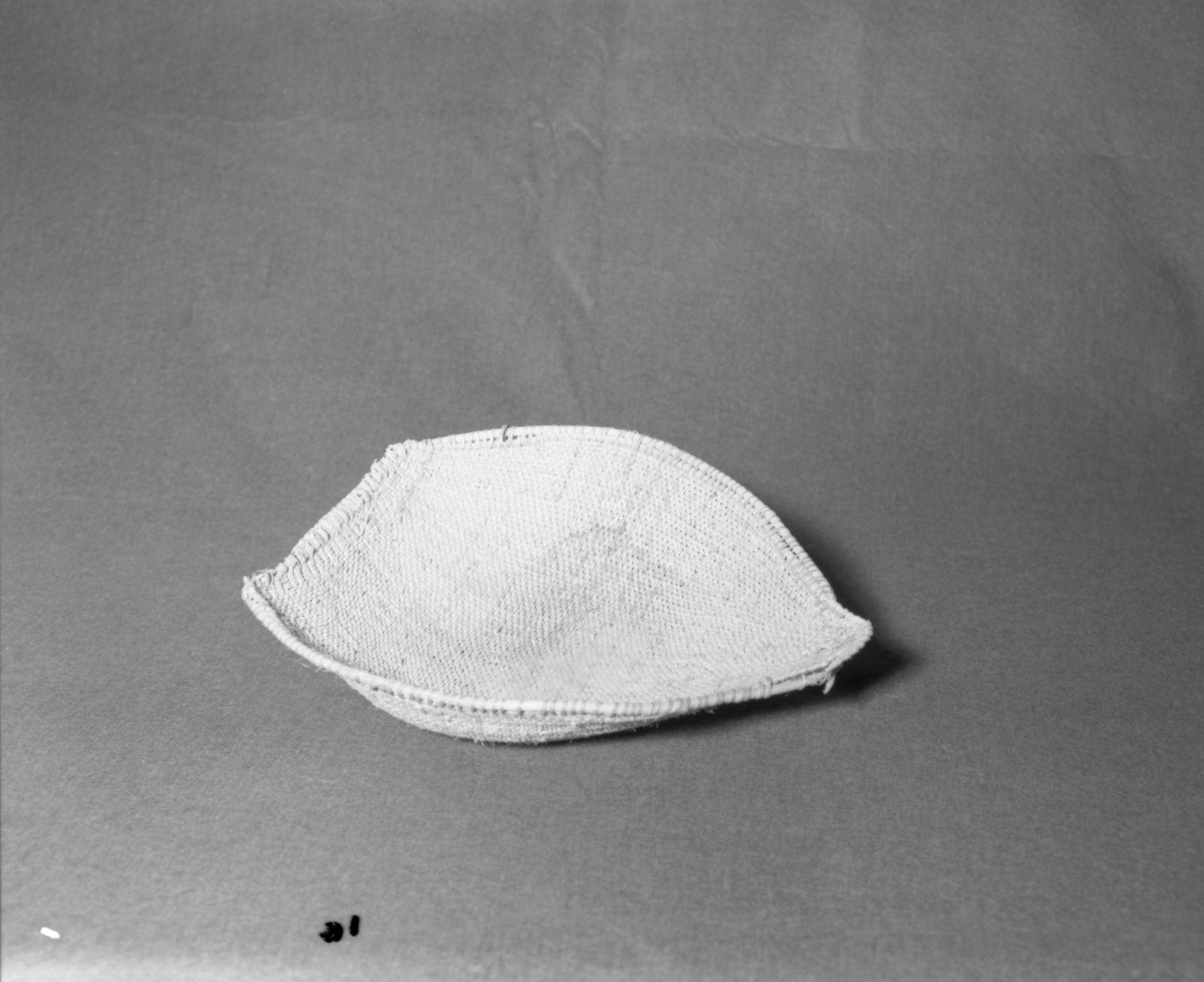 Mrs. Donald Segerstrom Collection. Object: Paiute winnower. Dimensions: 13 1/2 x 11 1/2". Materials: Entirely willow. Technology: Diagonally twined, rimstick attached with warp rods which are twined over each other and then cut. Photographed by Michael Dixon. Catalogued by Craig Bates and Barbara Beroza. Yosemite Collections, National Park Service. 1/83.