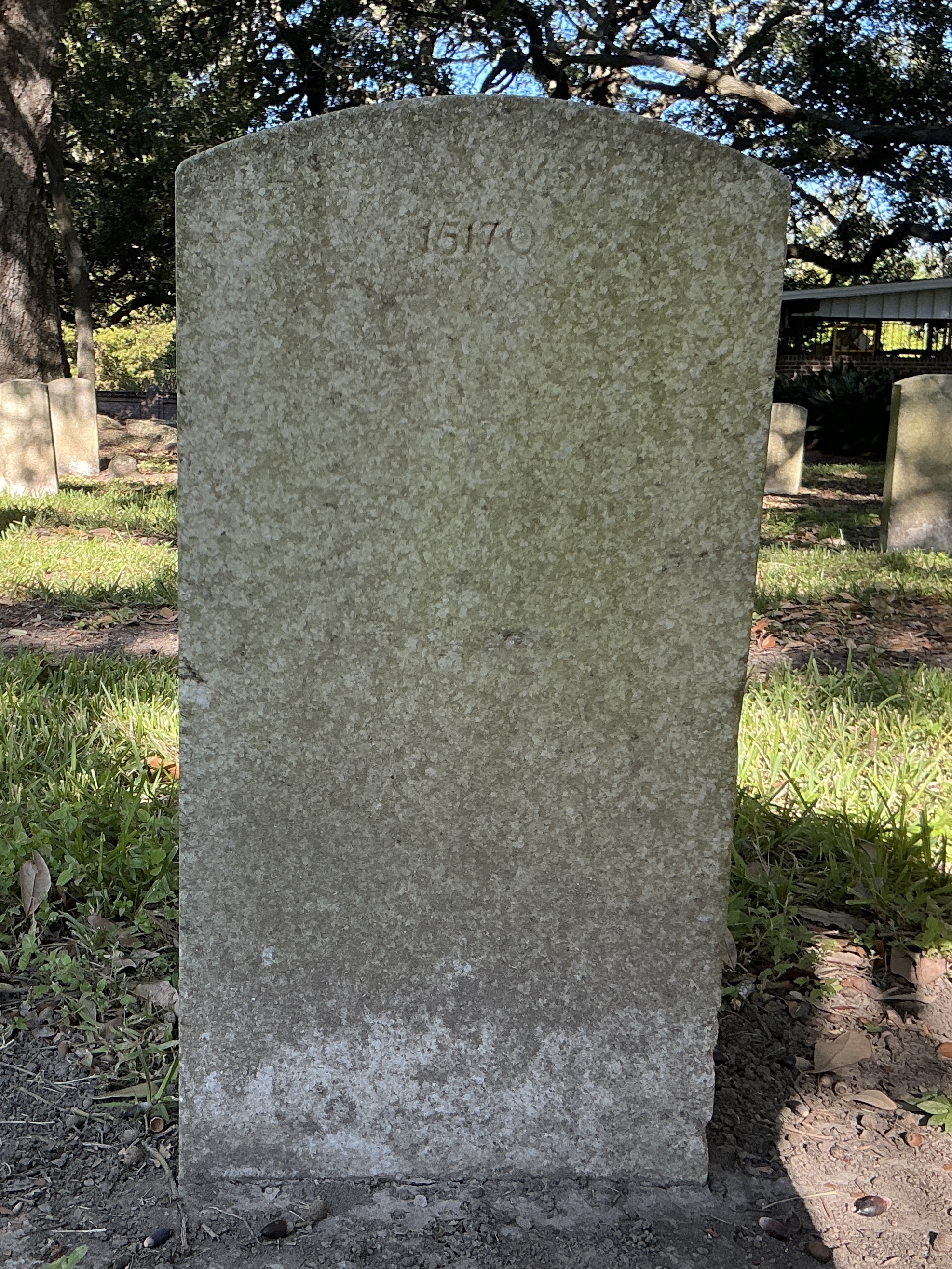 Back of upright marble headstone with flat face.