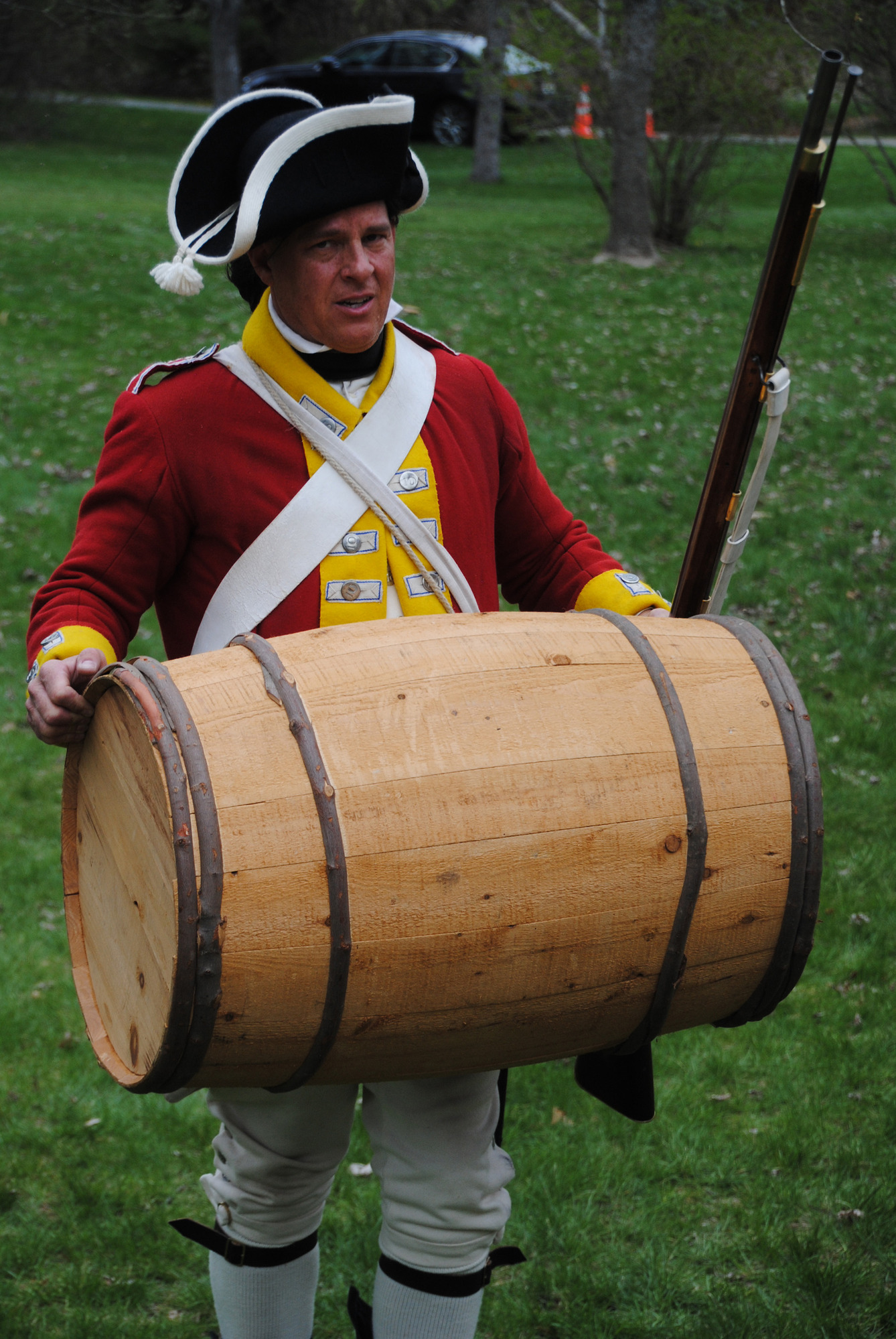 British soldier carrying large barrel. 