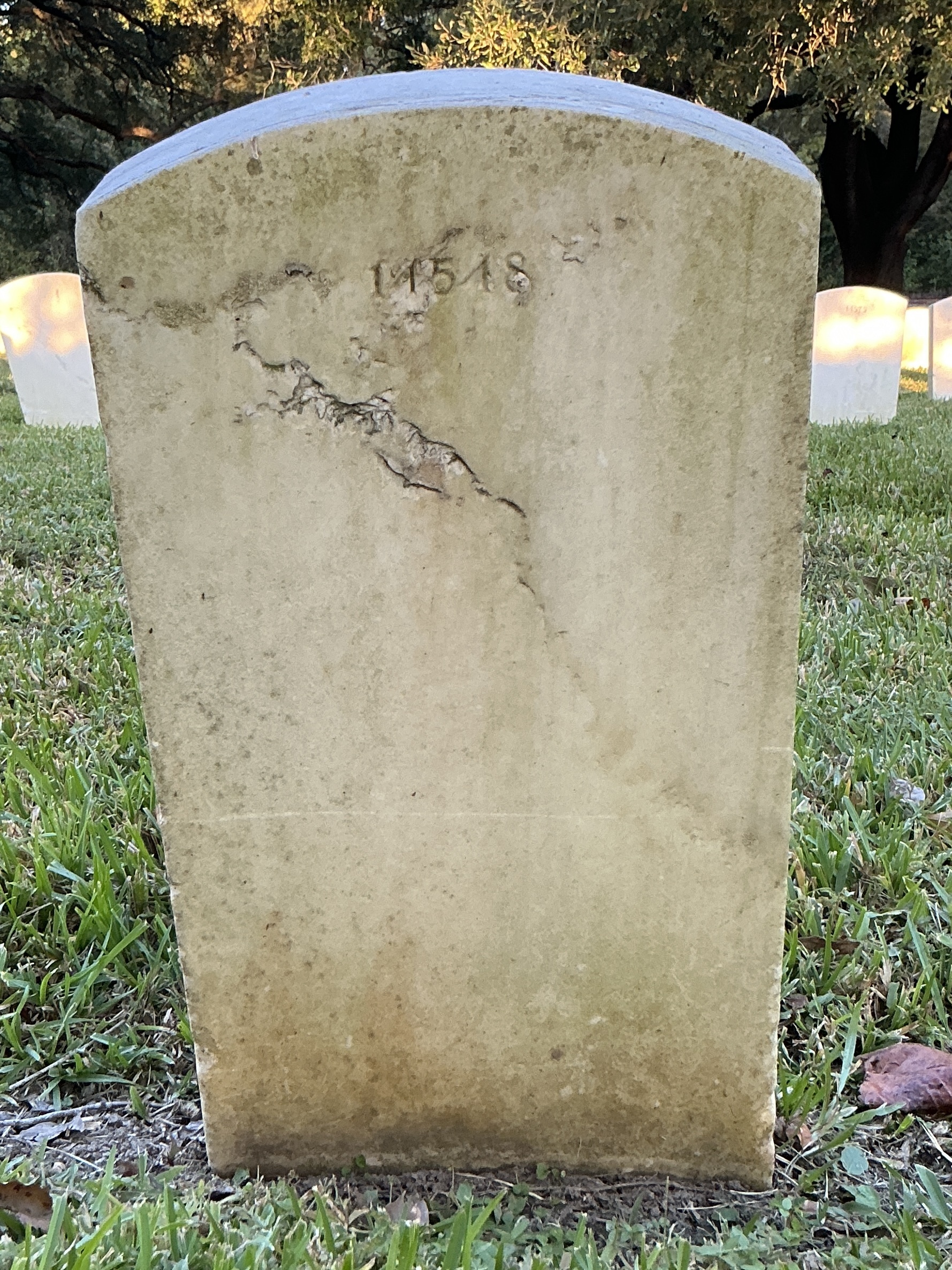 Back of upright marble headstone with flat face.
