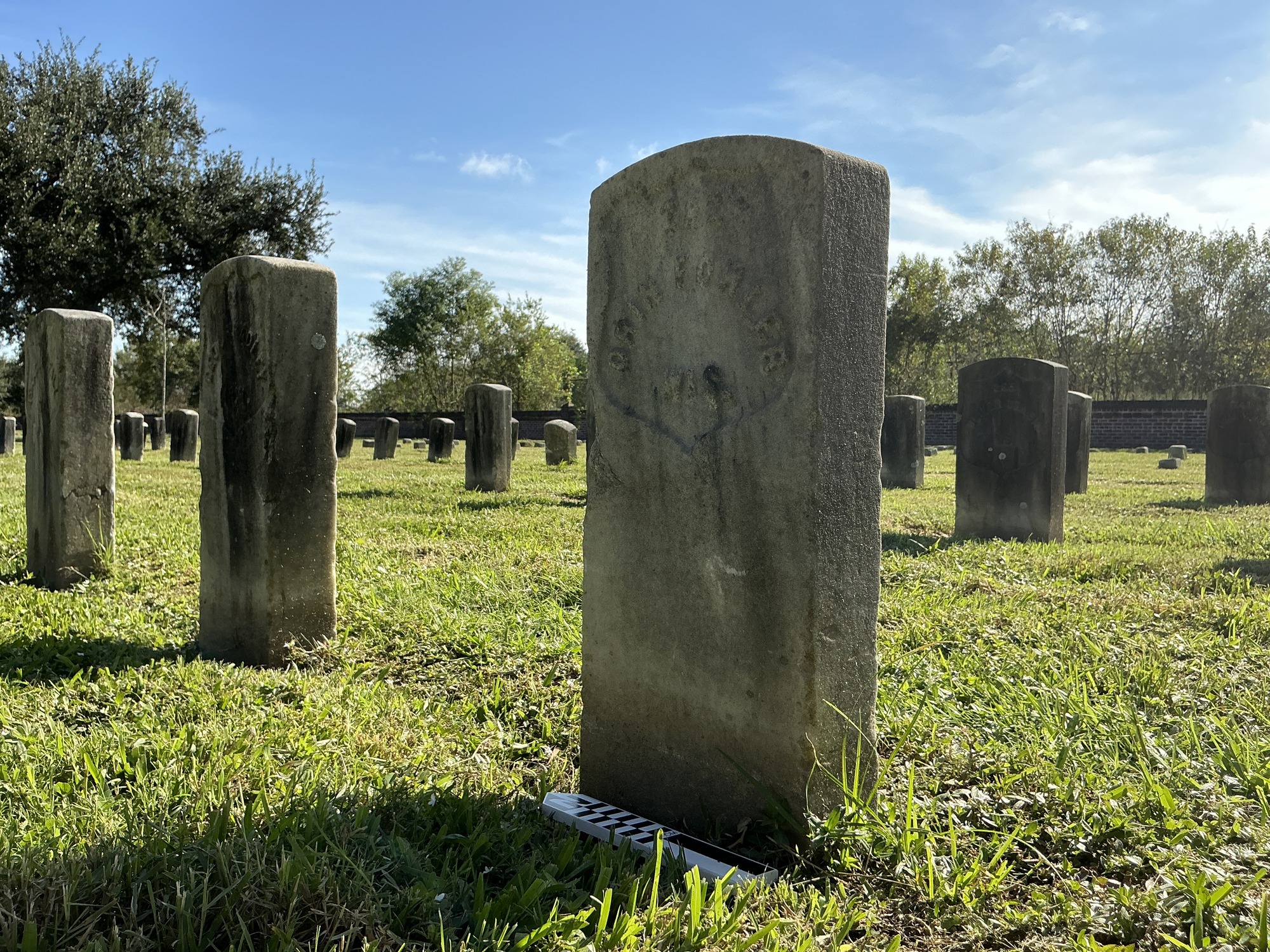 Extra image of historic upright marble headstone with recessed shield face.