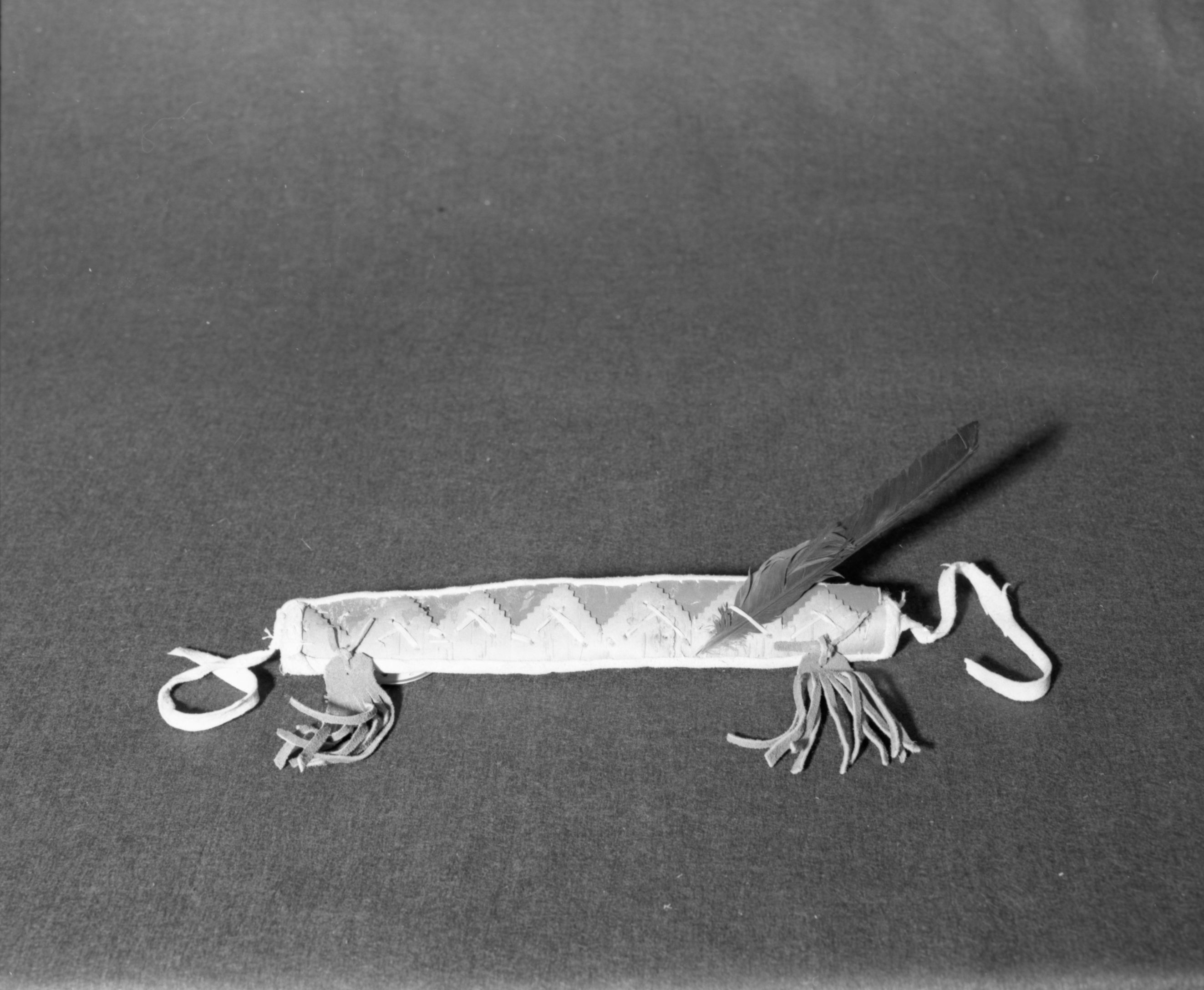 Marie Rozier Collection, Catalog No. CAN-6. Object: Shushwap headband. Dimensions: 12 x 2". Materials: Birchbark; spruce root, cotton thread, brain-tanned buckskin; commercial tanned leather; raven feather. Collection History: Made by eighty year old woman. bought at Salmon Arm, B.C., 1969. Photographed by Michael Dixon, December 1982. Catalogued by Craig Bates and Barbara Beroza. Yosemite Collections, National Park Service.