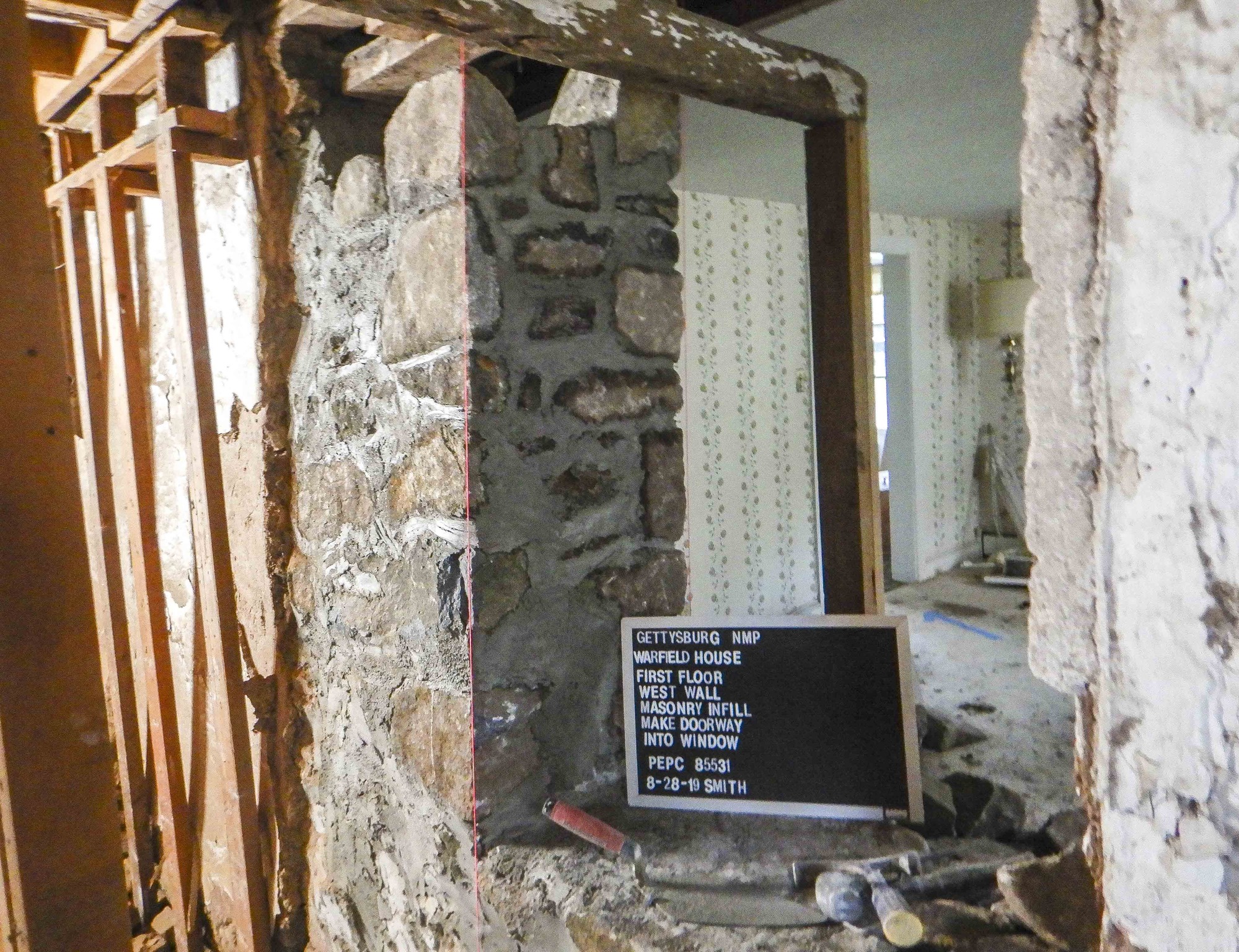 Stone and mortar have been built straight and plumb to accomodate the new window opening.