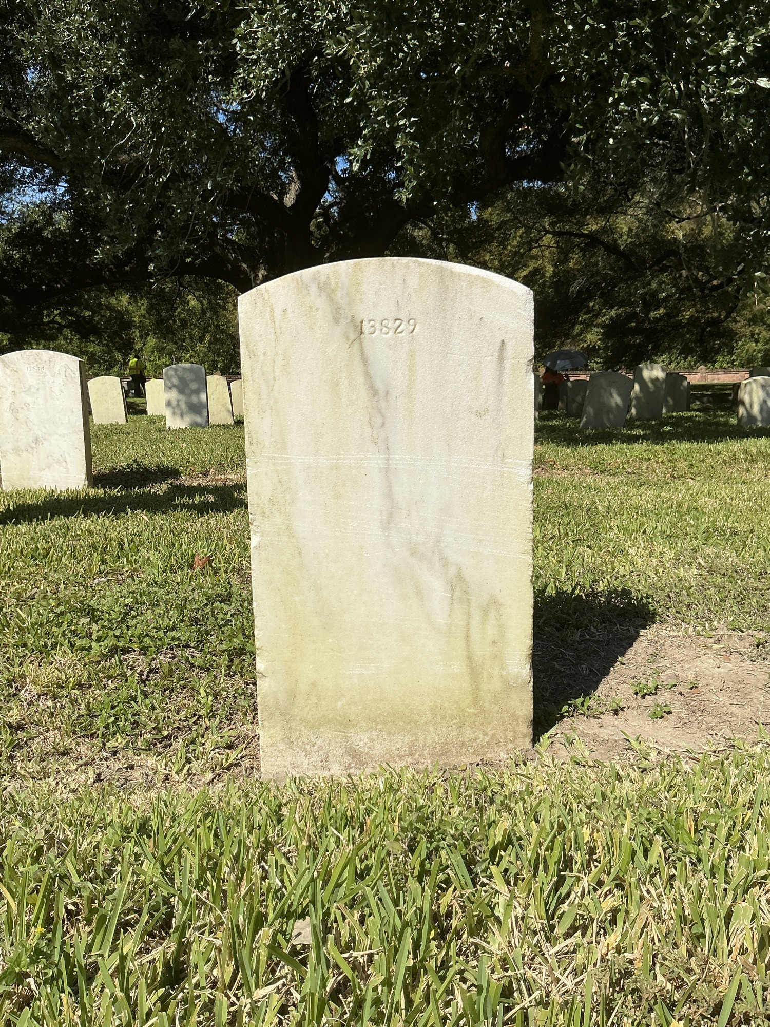 Back of upright marble headstone with flat face.