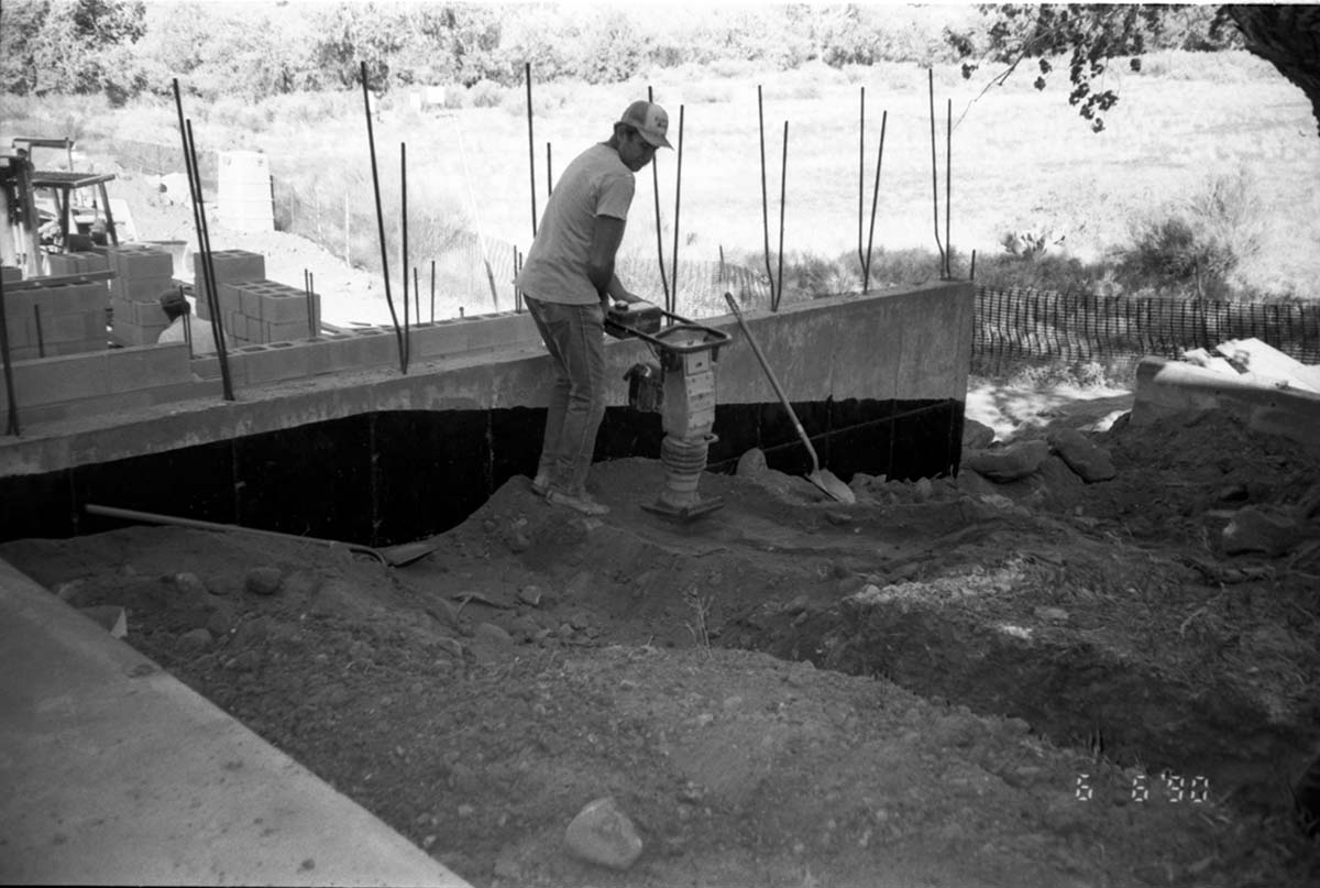 Man operating construction machine during the construction of headquarters addition.