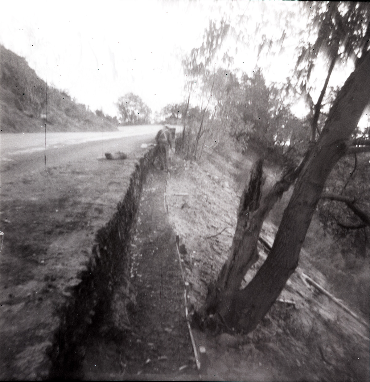 Man working on rock retaining wall alongside road at the tunnel.