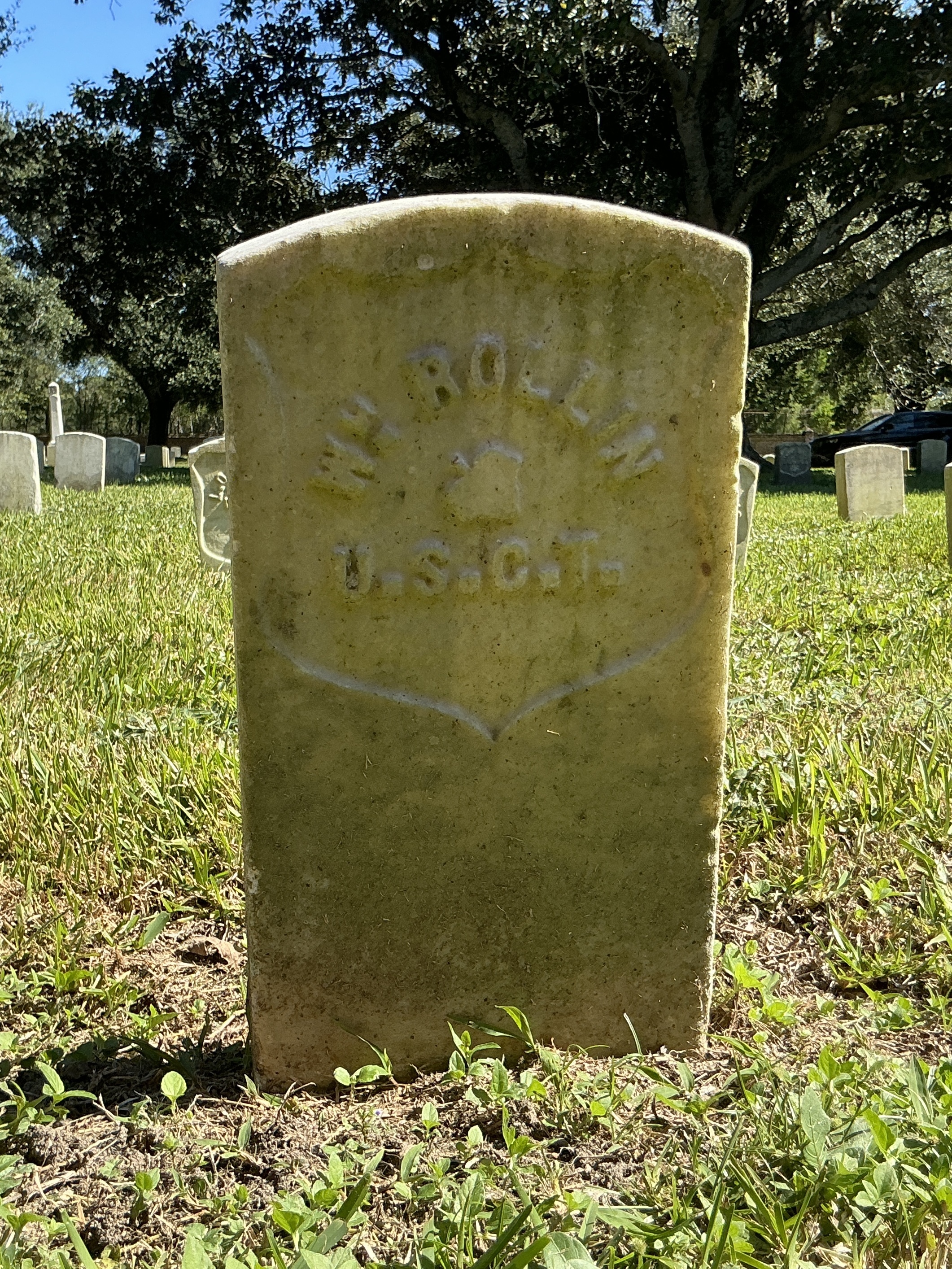 Back of historic upright marble headstone with recessed shield face.