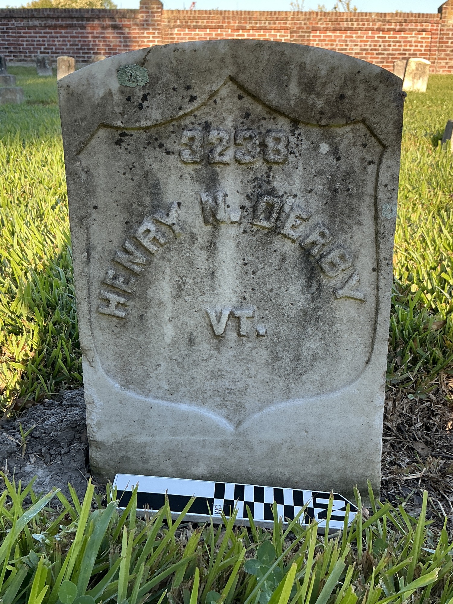 Extra image of historic upright marble headstone with recessed shield face.