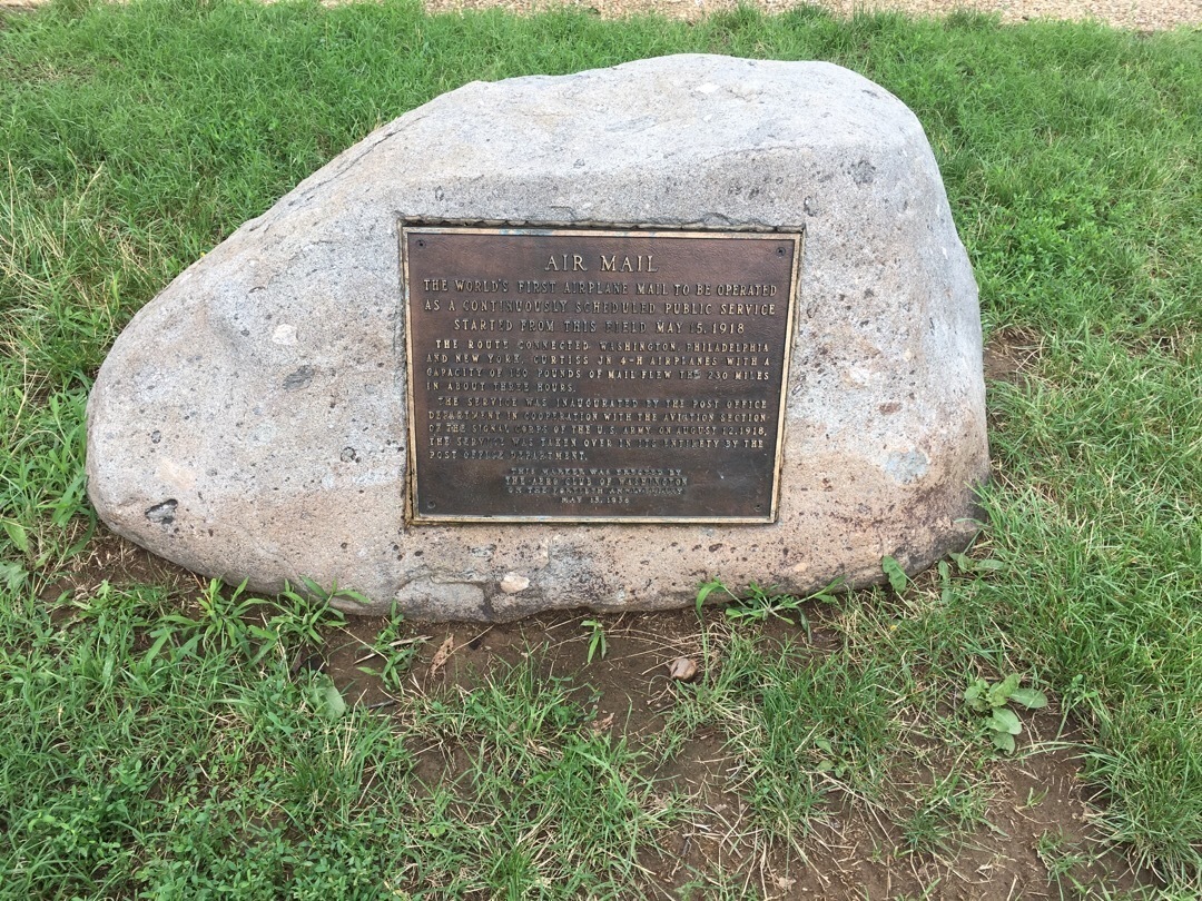 A stone with a plaque on it noting the first air mail delivery
