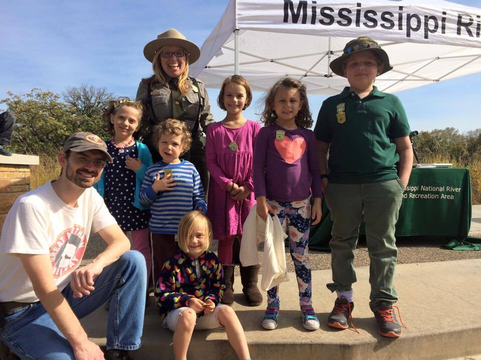A group of people in front of a tent.  