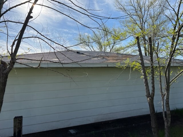 Image of building from behind with trees in front of it.
