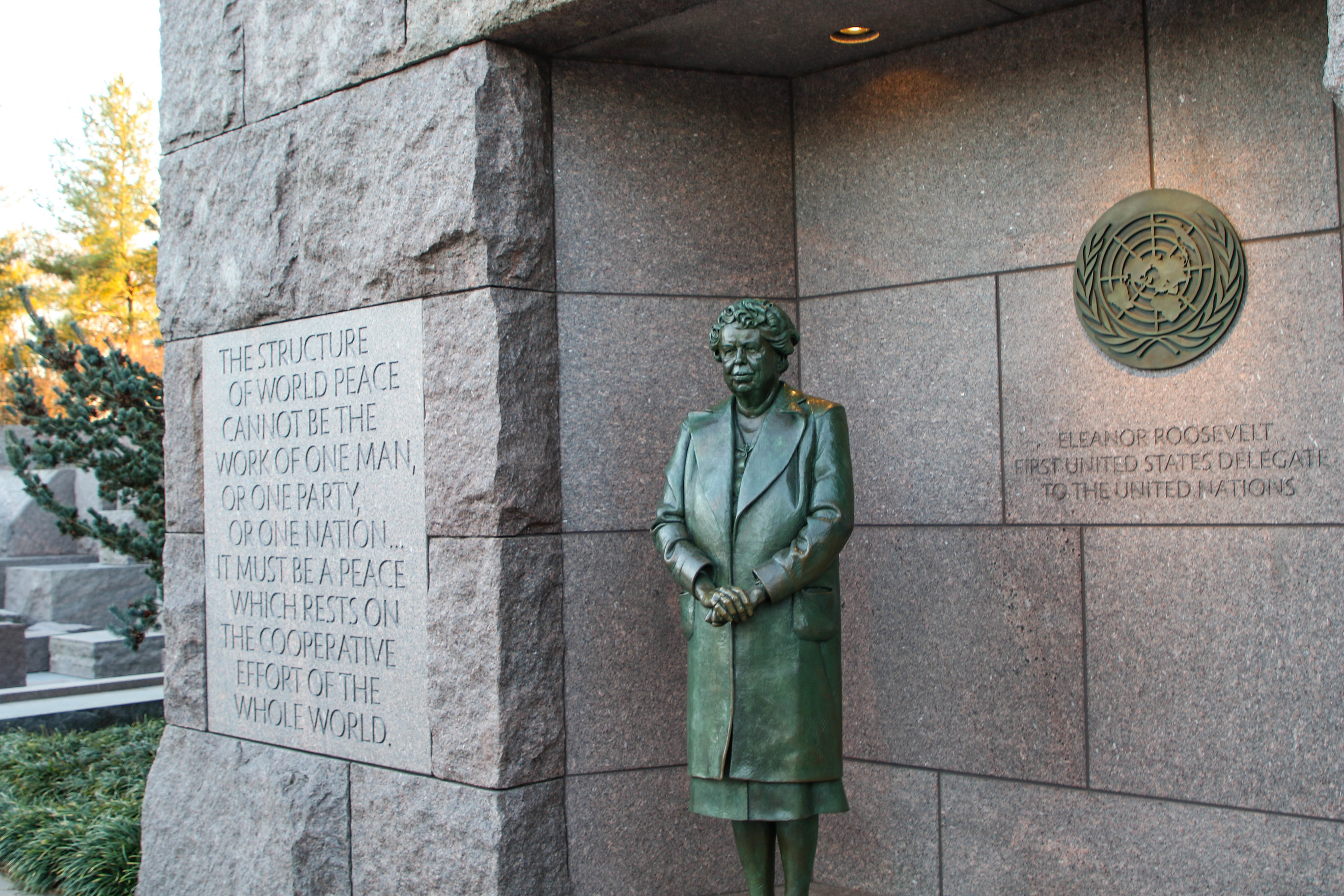 Statue of Eleanor Roosevelt in a stone wall with inscriptions