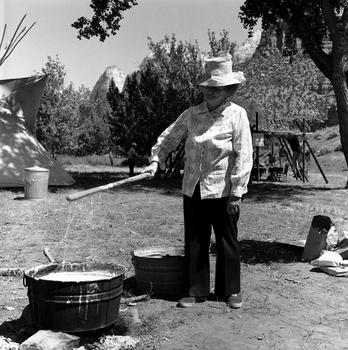 Woman demonstrates making of hand dipped candles at the second annual Folklife Festival, Zion National Park Nature Center, September 1978.