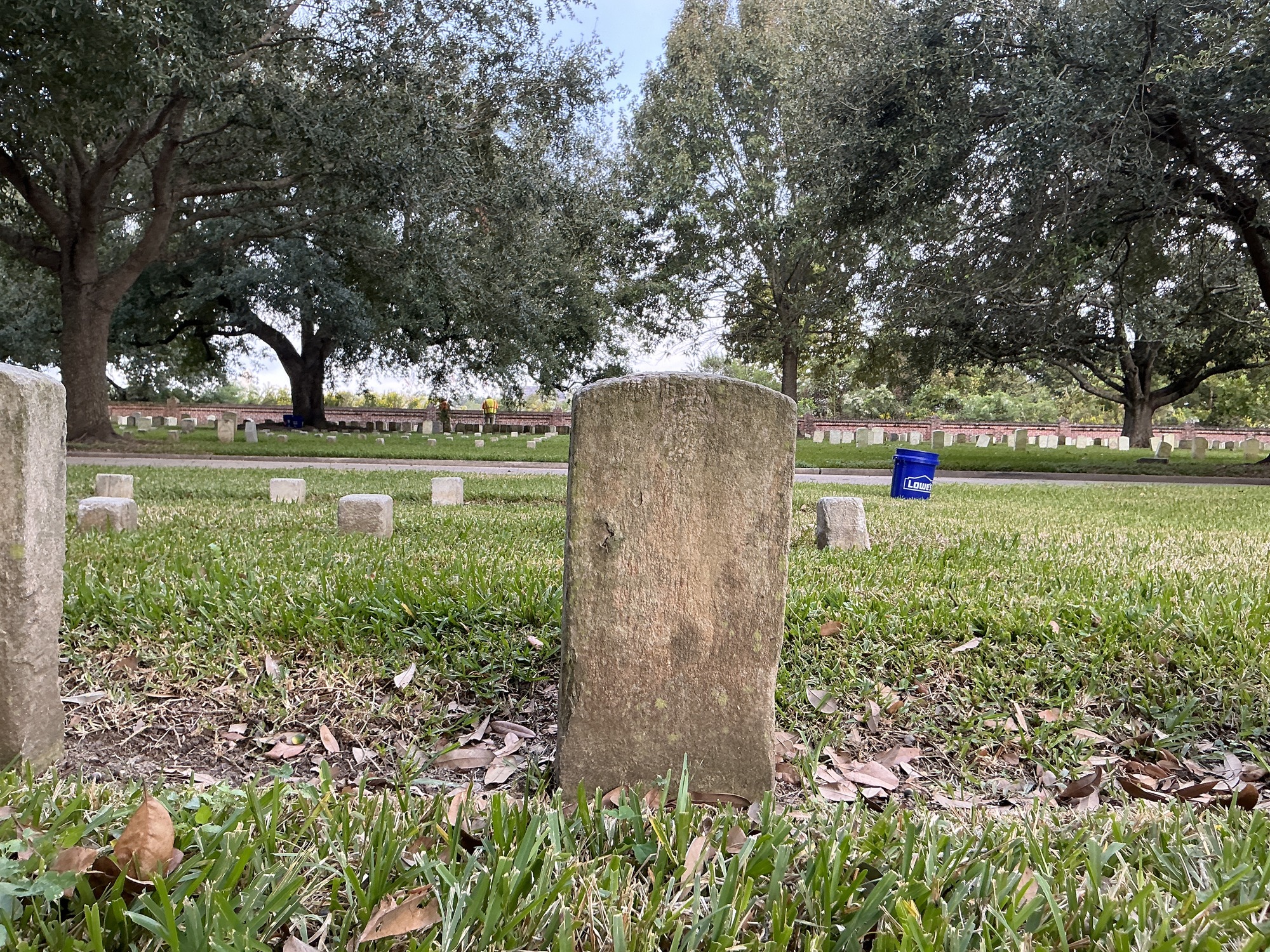 Back of historic upright marble headstone with recessed shield face.