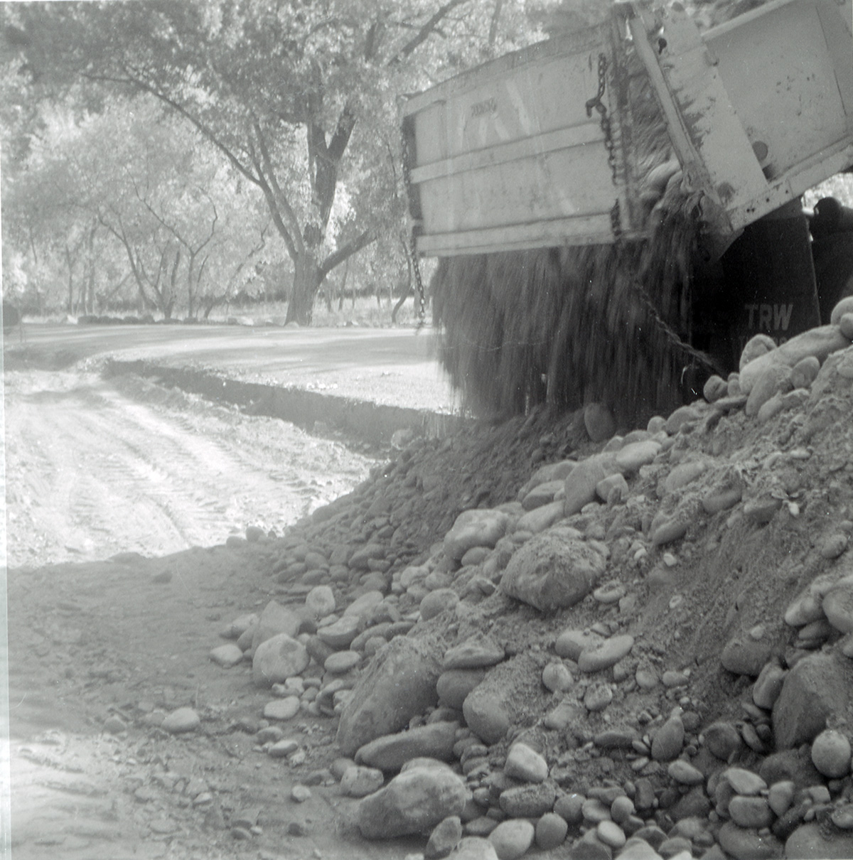 Dump truck dumping gravel and rocks to be used for road work along the scenic canyon drive near the Grotto.