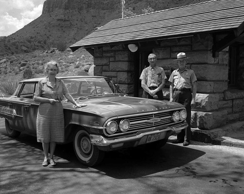Assistant Superintendent Charles Humberger stands with Ernest and Stella Gisseman of Midvale, Utah, by their vehicle at the park entrance station. The Gissemans are the Millionth Visitor to Zion National Park.