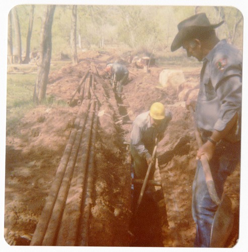 Workers uncovering the irrigation ditch in South Campground.
