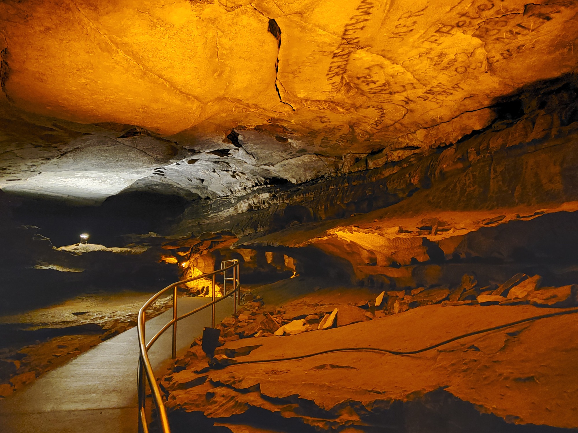 Historic signatures on the cave ceiling along the trail.
