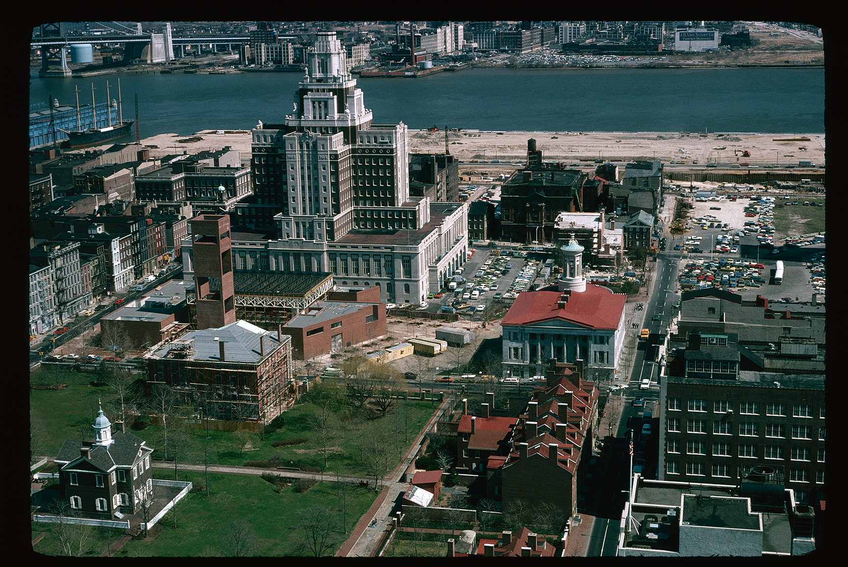 Independence National Historical Park. Aerial. Looking  east past 4th Street, between Chestnut & Walnut, towards Delaware River. Buildings front to back (left to right): Carpenters Hall, First Bank of the United States and Walnut Street houses, (Old) Visitor Center and Merchants Exchange, Custom House.