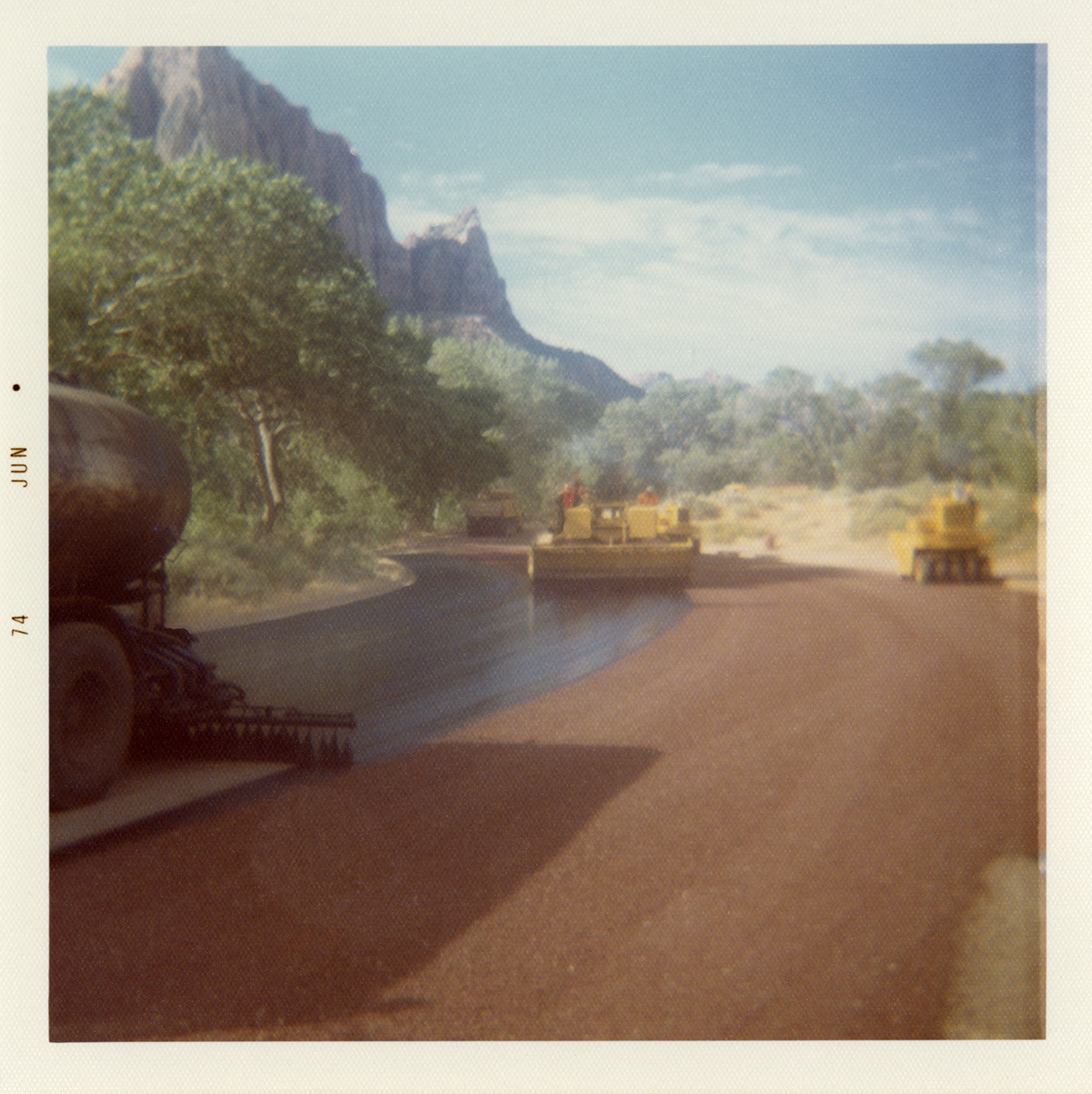 Construction vehicles chipsealing Zion roads.