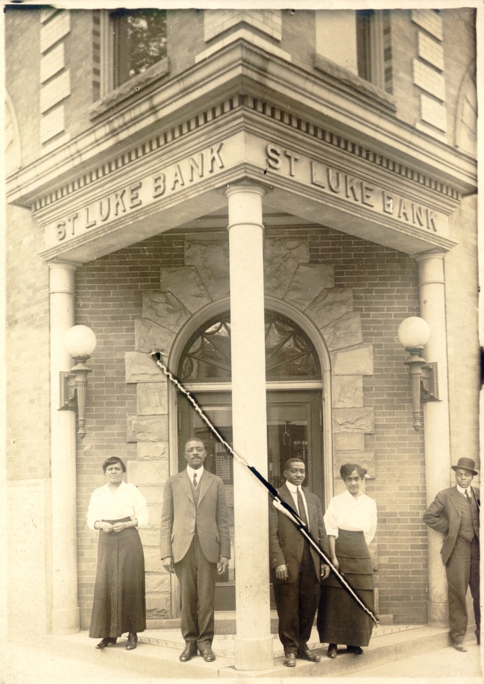 St. Luke Penny Savings Bank entrance with staff.