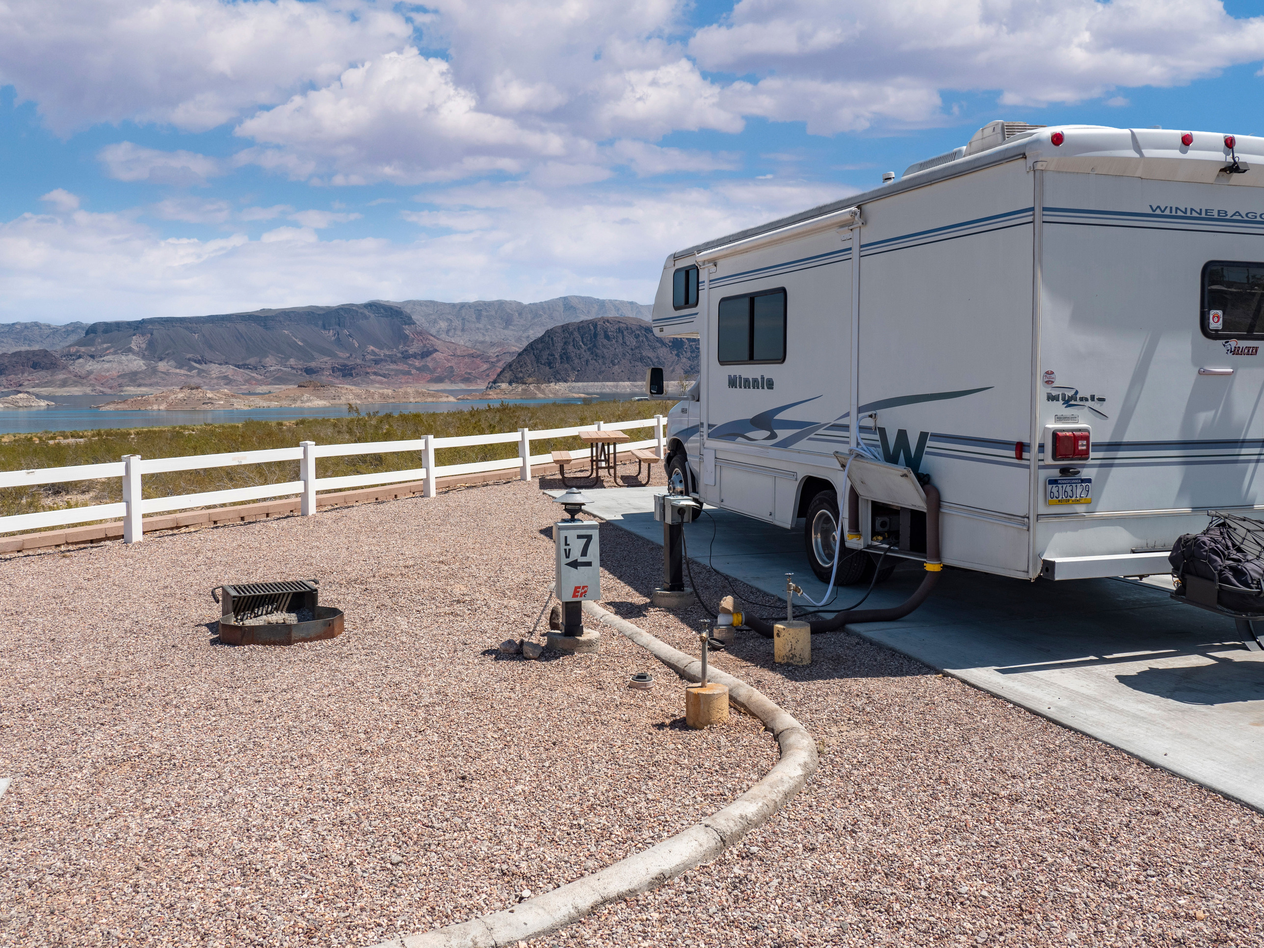 RV on cement pad overlooking mountains and lake