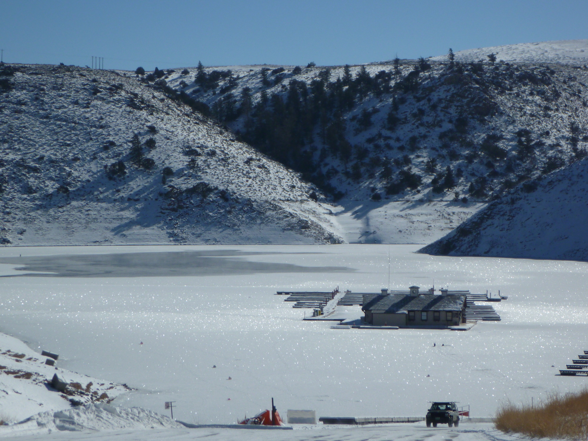 Snow and ice on a reservoir with a building out away from land