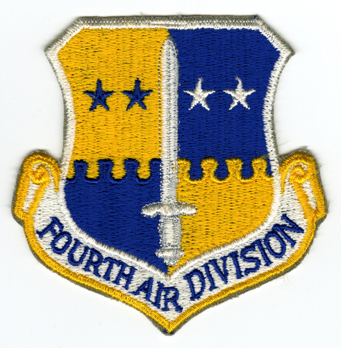 Blue, white, and yellow shield shape. Shield separated into quarters, divided horizontally with white sword. Top left is yellow with two (2) blue stars, top right is blue with two (2) white stars. Bottom left is blue and bottom right is yellow, neither have any design. White scroll along bottom with FOURTH AIR DIVISION" stitched in blue."
