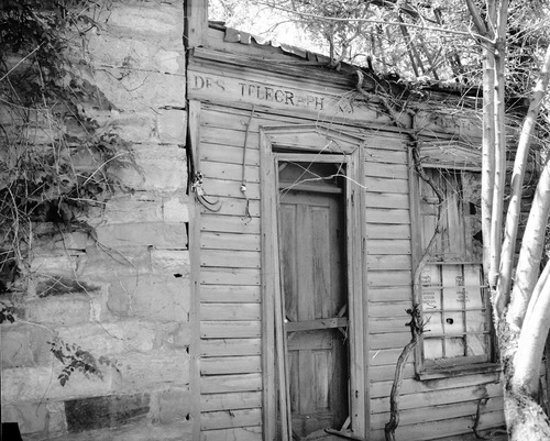 The Deseret Telegraph Company telegraph office in Rockville, Utah. Sign reads: Des Telegraph. Style of print for sign at Pipe Spring National Monument.