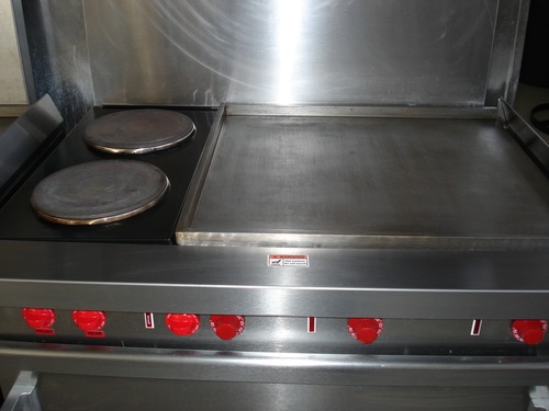Close up of the stove in Camp Greentop showing the burners and griddle.
