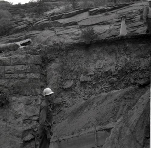 Man working on retaining wall repairs along East Rim road.